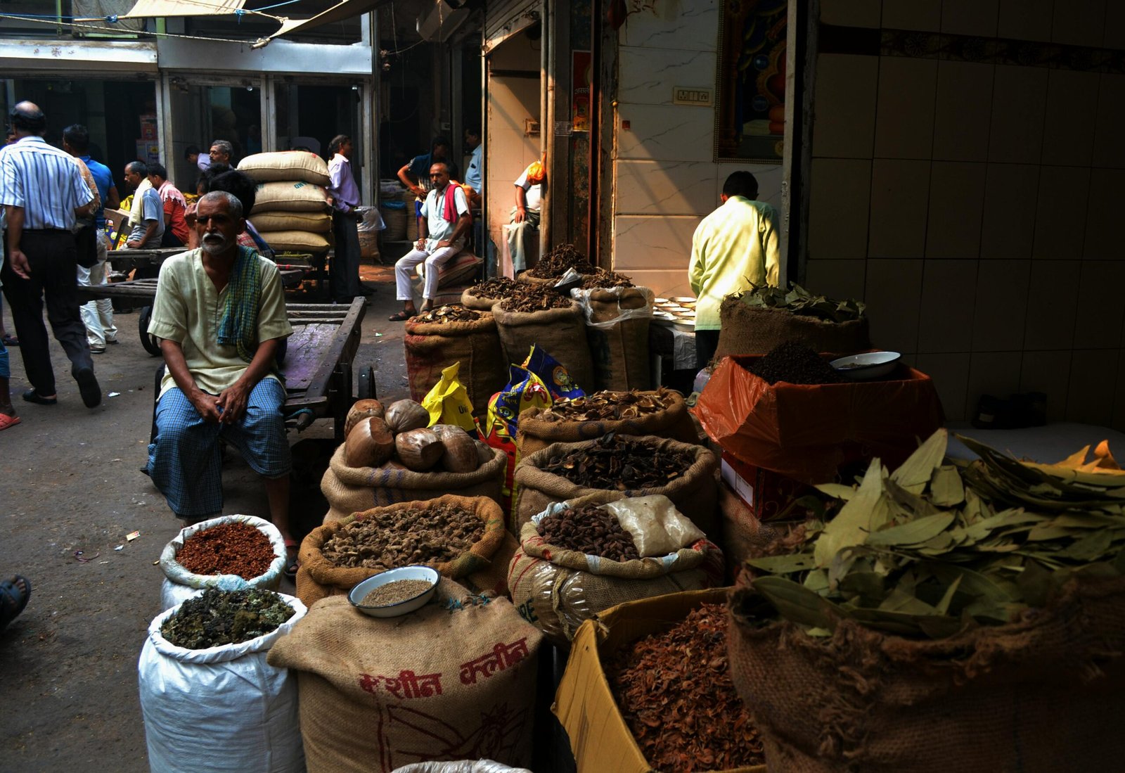 A vibrant outdoor spice market showcasing various herbs and spices with local vendors.